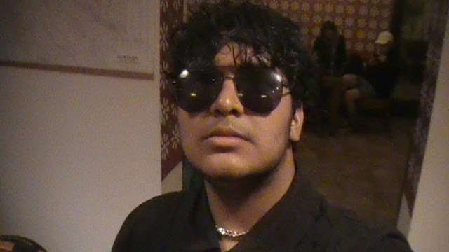 Abutalha wearing sunglasses indoors